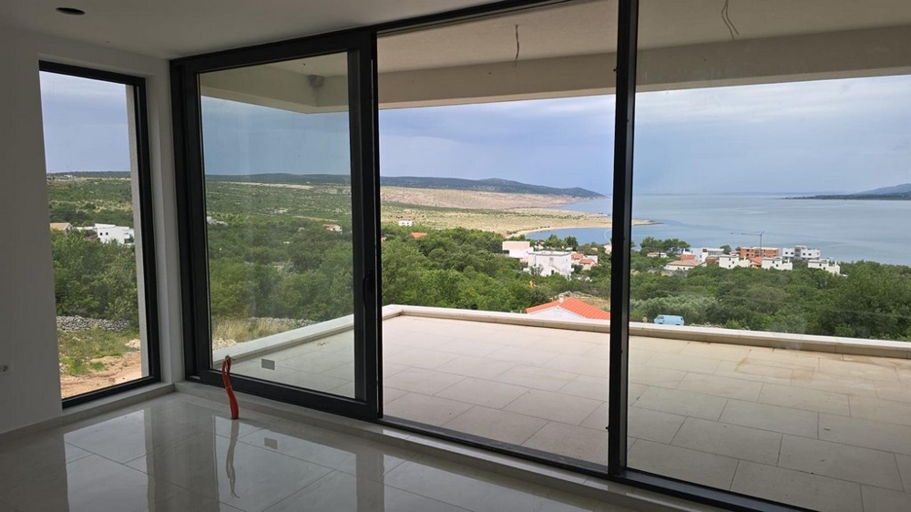 Byggnaden är inbäddad i ett grönt Medelhavslandskap.