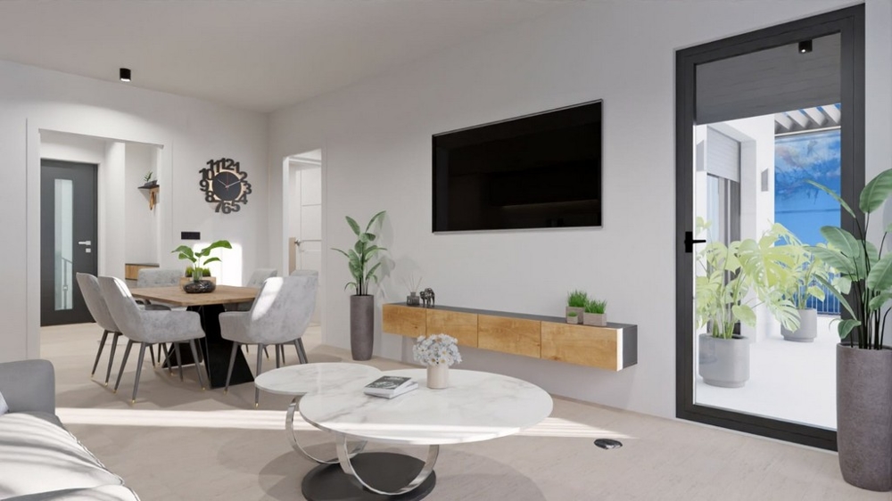 Modernt vardagsrum med matplats, TV och tillgång till balkong med havsutsikt.