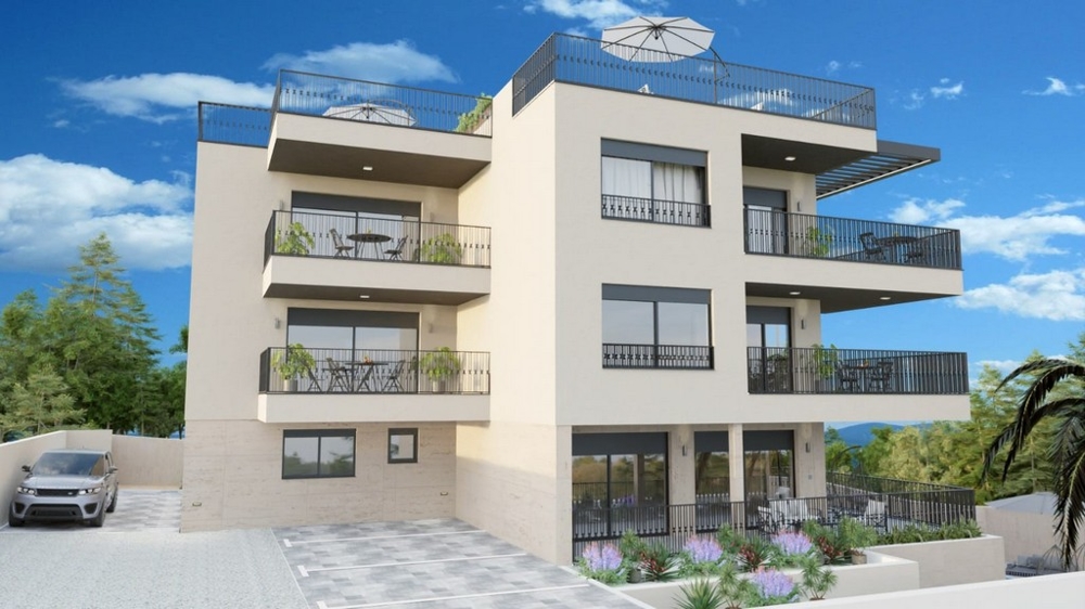 Exteriör vy av det nya bostadshuset med flera balkonger och takterrasser.