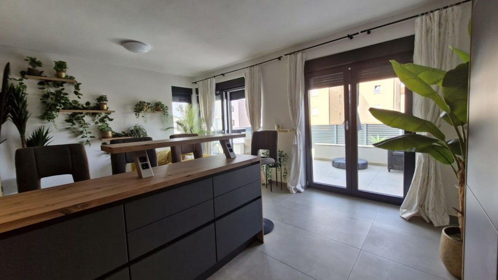 Vardagsrum med matplats och utgång till terrassen.