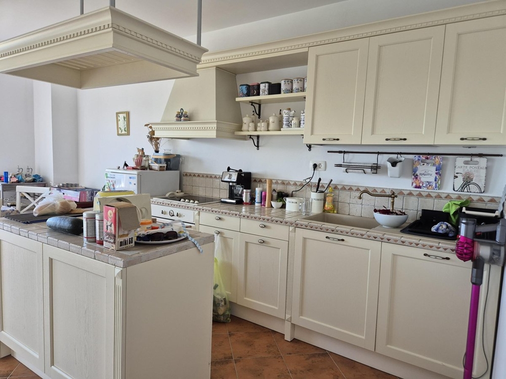 Ytterligare en vy över det rymliga köket med ljusa skåp