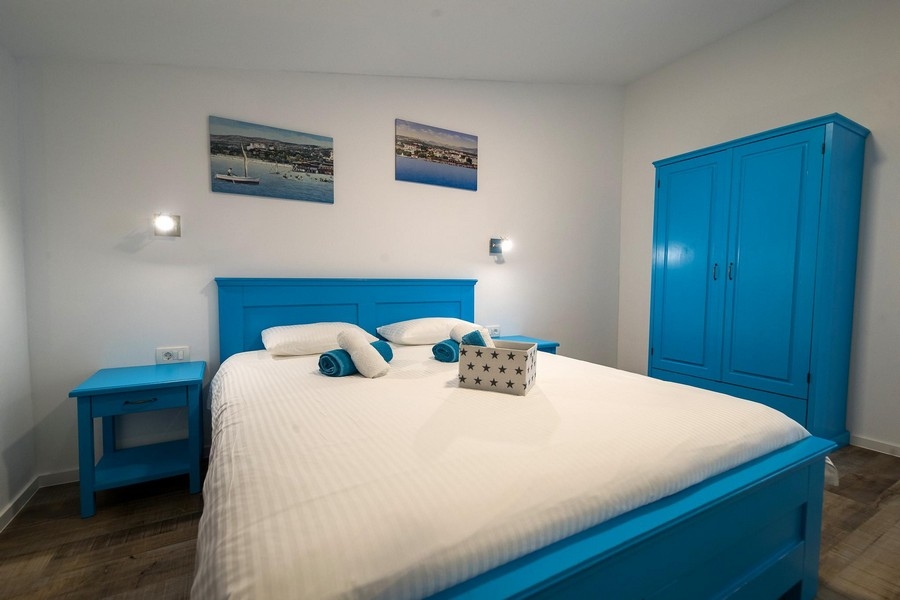 Sovrum med blå säng och garderob