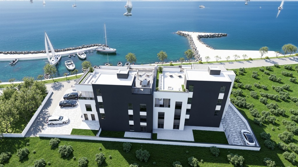 Drönarbild av den nya byggnaden med tillgång till havet och parkeringsplatser