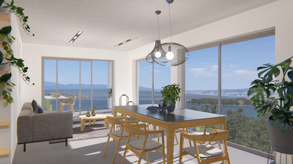 Ljust vardagsrum med matplats och panoramautsikt över havet