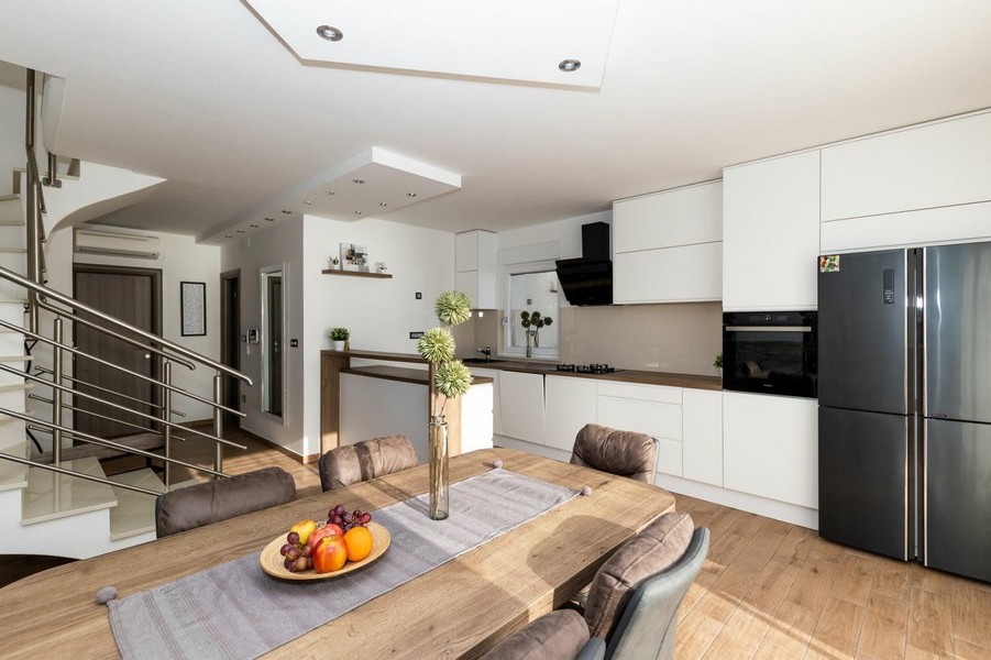 Modernt kök med matplats och tillgång till trappan