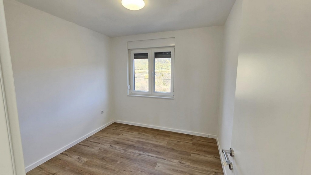 Sovrum med fönster och trägolv