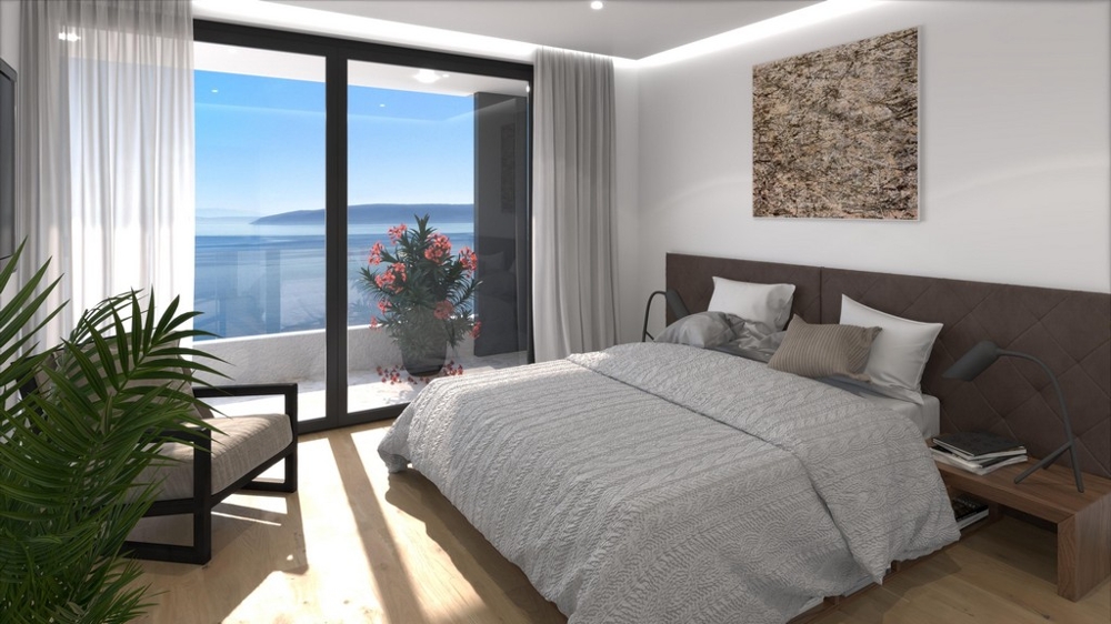 Sovrum med stort fönster och havsutsikt