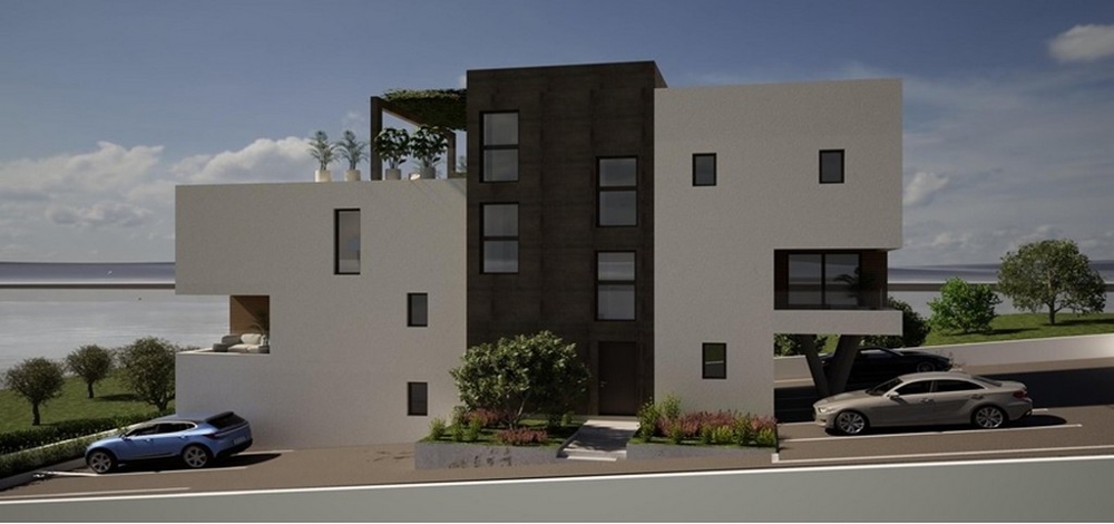 Gatuvy av en modern ny byggnad med parkeringsplatser