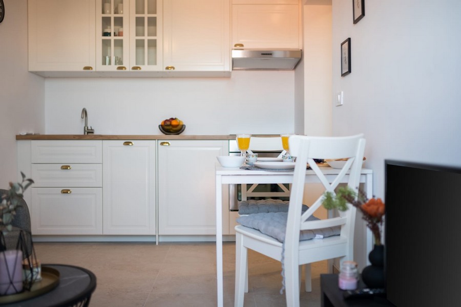 Vitt pentry med bänkskiva i trä