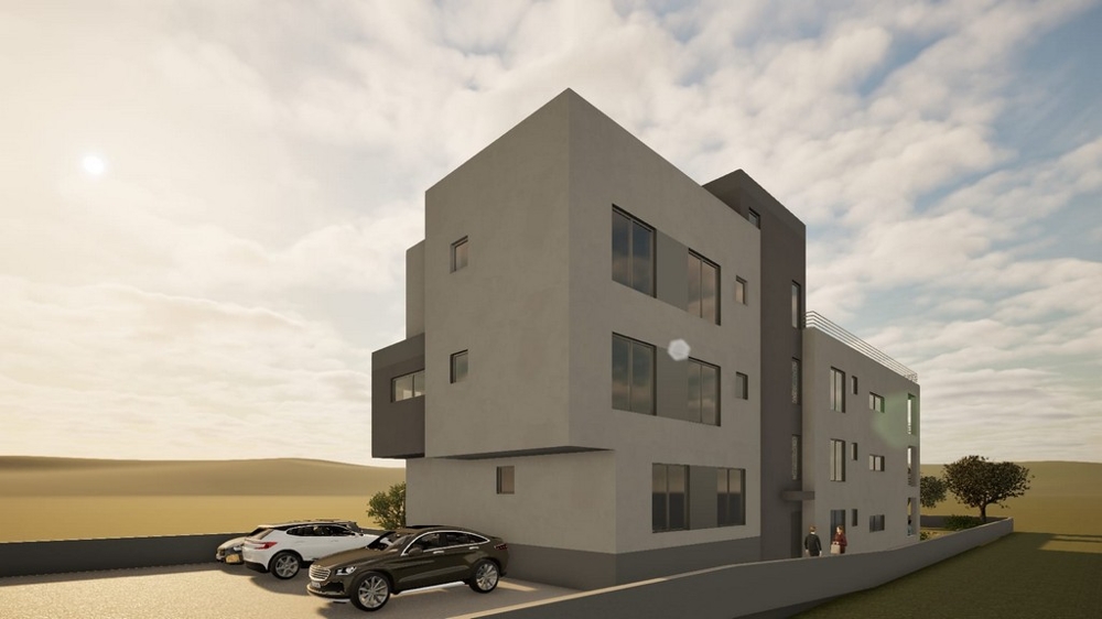 Nytt bostadshus med parkeringsplatser framför huset