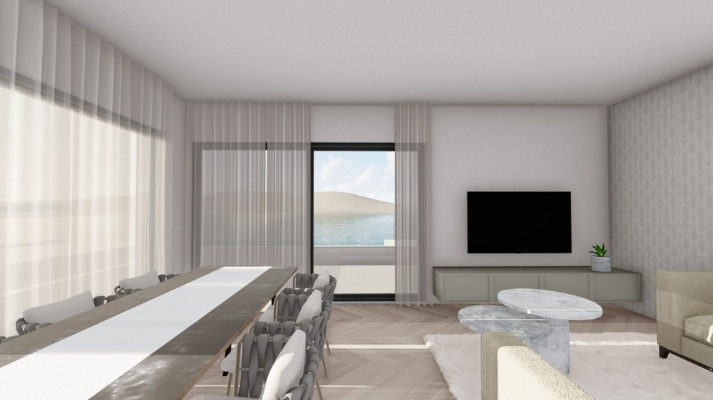 Modernt vardagsrum och matplats med direkt tillgång till terrassen och havsutsikt