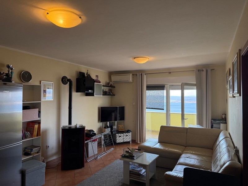 Vardagsrum med TV-del och utgång till balkong