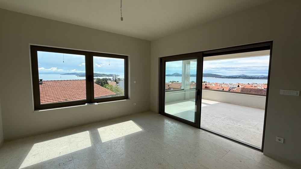 Öppet vardagsrum med havsutsikt och tillgång till terrassen