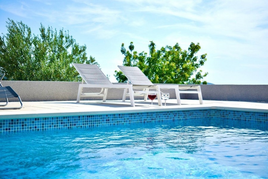 Pool med solstolar utomhus