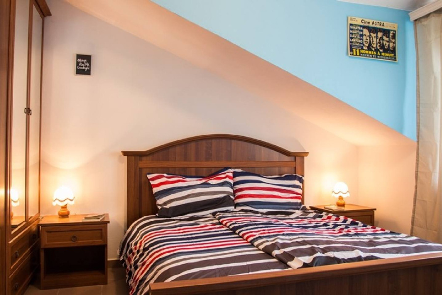 Vindsrum med dubbelsäng och fönster i Pula-regionen.