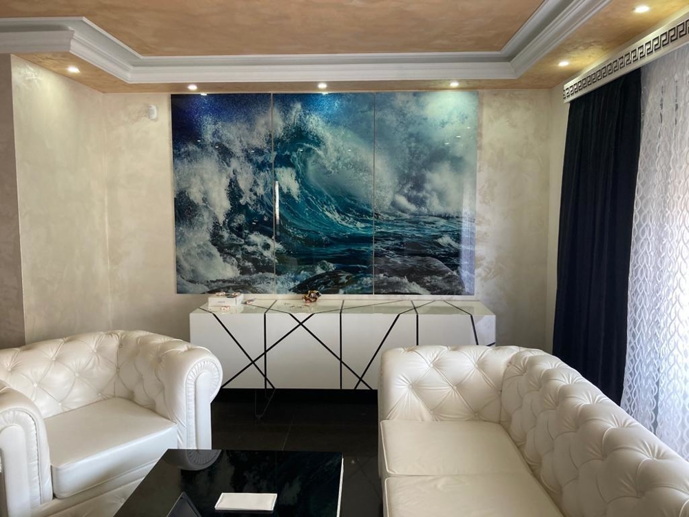 Lyxigt inrett vardagsrum med en bild av havet.