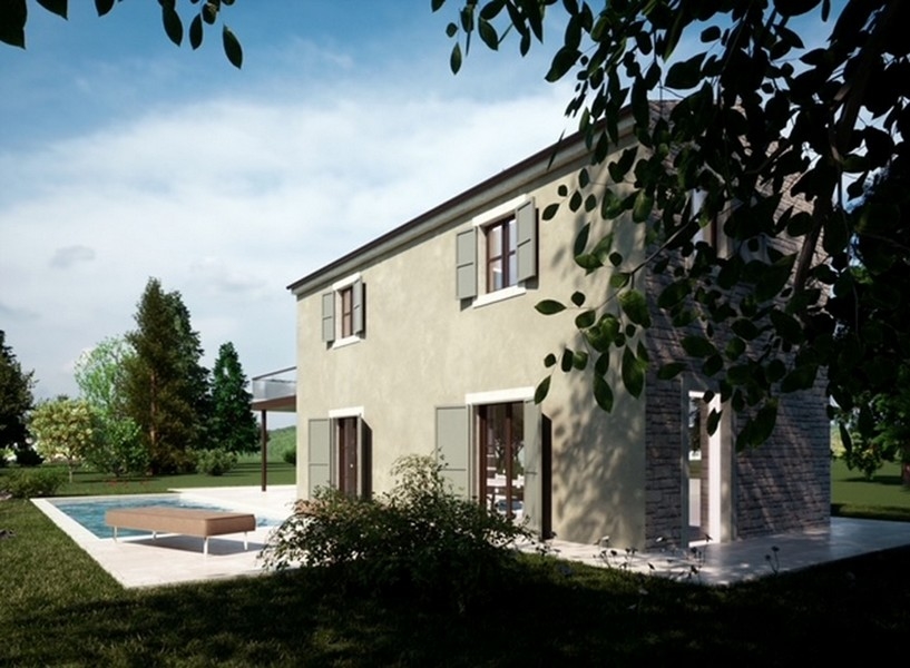 Utsikt över en fastighet i Istrien med utsikt över havet, omgiven av rött löv och en klar himmel.