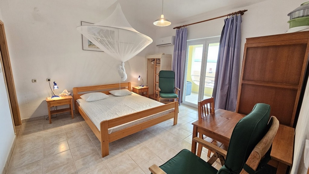 Sovrum med stor säng och tillgång till balkong i hus till salu i Karlobag