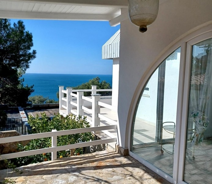 Terrass till en villa till salu med utsikt över Adriatiska havet på ön Cres, Kroatien, med vita räcken och träd