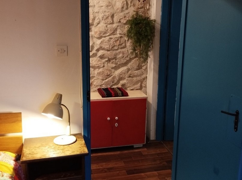 Sovrum med stenväggar och rustik charm, perfekt för att köpa ett hus i Kroatien.