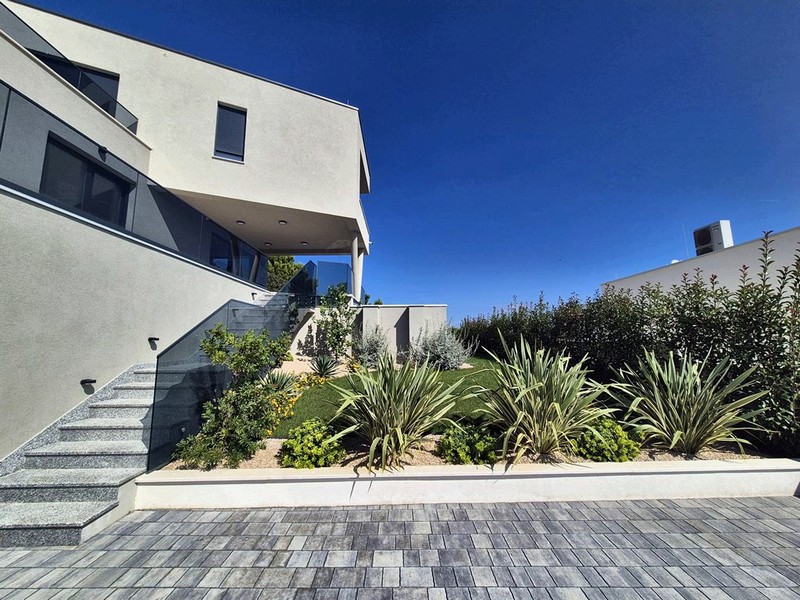 Interiörvy av ett rum i skalet med golvvärme, stora fönster med utsikt över de närliggande byggnaderna