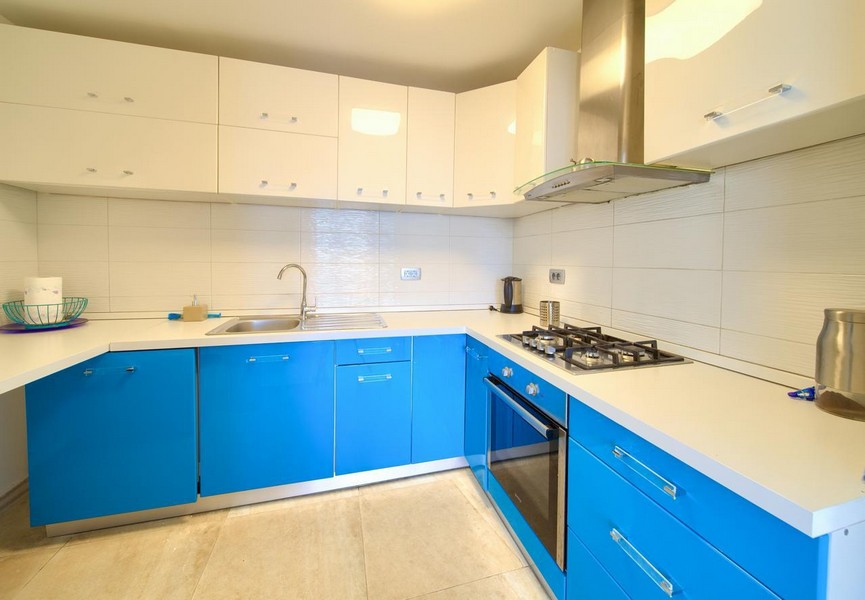 Kök med blå skåp och modern utrustning