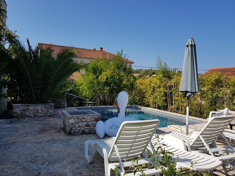 Solterrass med pool och solstolar