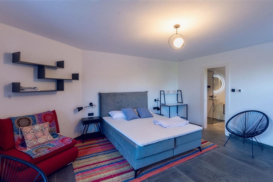 Sovrum med dubbelsäng och badrum