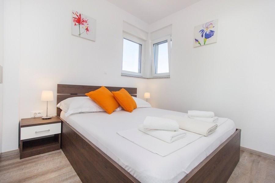 Ljust sovrum med dubbelsäng och sängbord