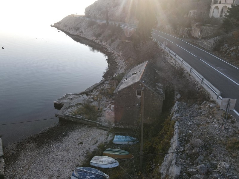 Stenhus precis vid havet nedanför kustvägen i Kroatien