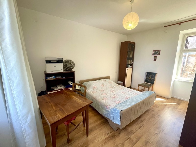 Sovrum med dubbelsäng och trägolv