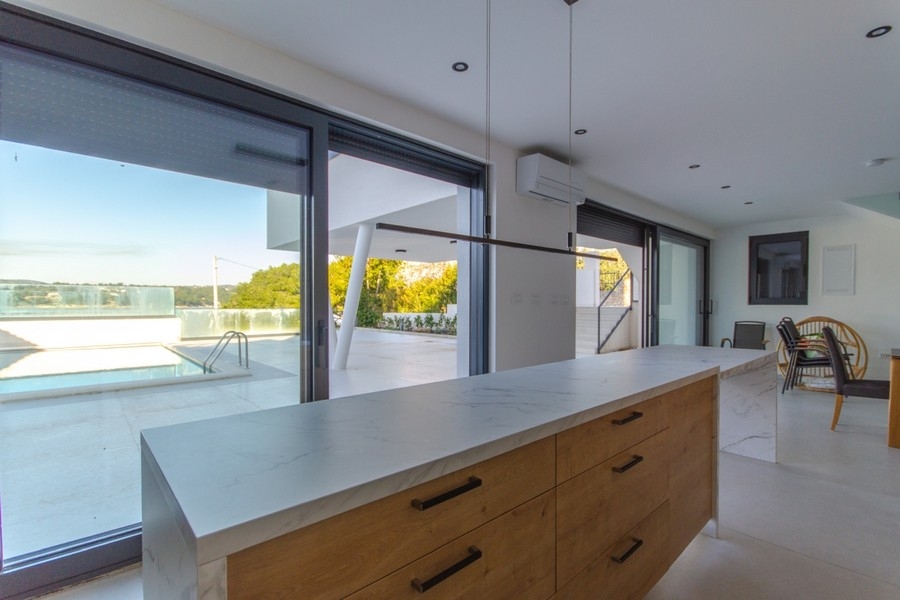Öppet kök med utsikt över fastighetens pool.