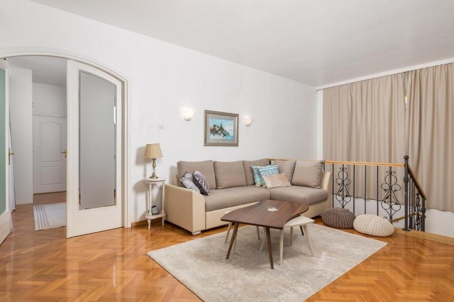 Vardagsrum på övervåningen med soffa och parkettgolv