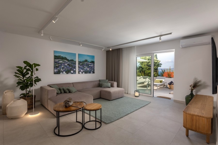 Vardagsrum med soffa och utgång till terrassen