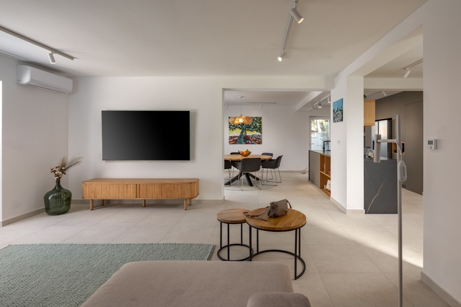 Öppet vardagsrum med TV och genomgång till köket