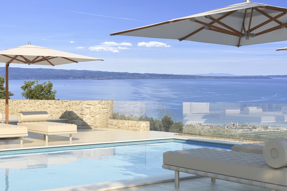 Pool med lounge och vidsträckt havsutsikt